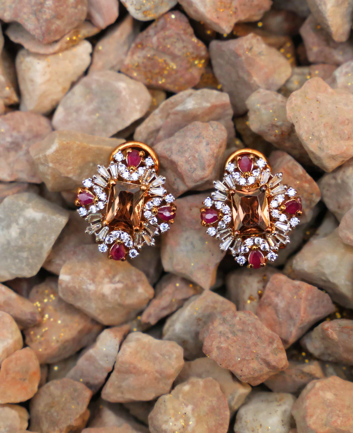 Rubies and the winter sun Rubies and The Winter Sun – Sterling Silver Stud Earrings with Treated Rubies, Champagne Zircons & Gold Plating | Big Jewellery - Image 1